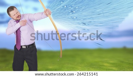 Businessman practicing archery shooting over green field in background
