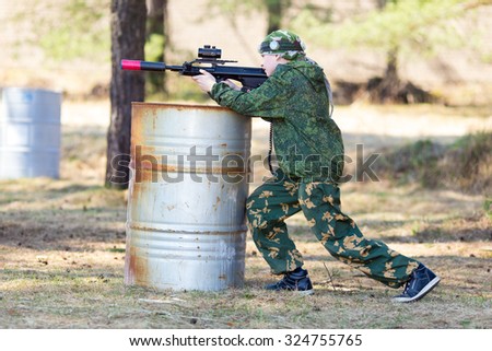 Boy with a gun playing lazer tag