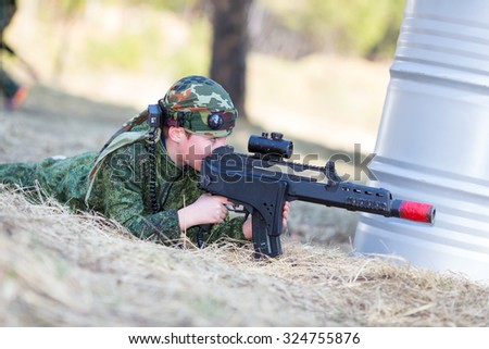 Boy with a gun playing lazer tag