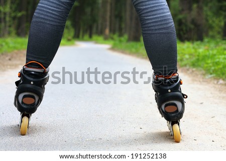 Sport roller skating on a forest path among the trees