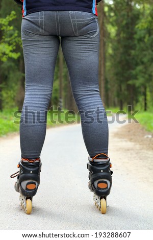 Sport roller skating on a forest path among the trees