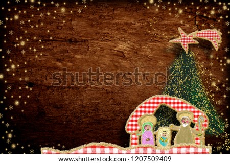 Cute Christmas Nativity Scene  greeting card. Nativity Scene made with cheerful cuts of fabrics and golden glitter on old wooden background with copy space.