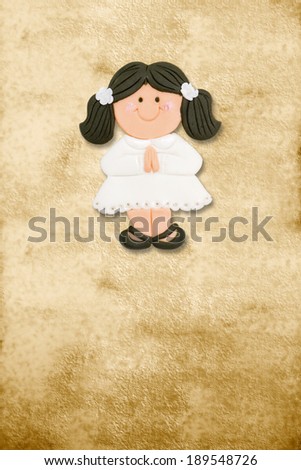 vertical card first communion, funny brunette girl in parchment background