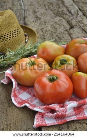 Red tomatoes from organic cultivation in old wooden table