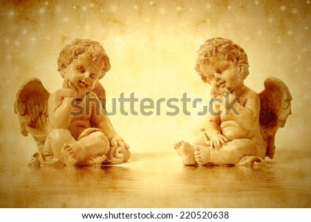 Two cute angels sitting in sepia tone