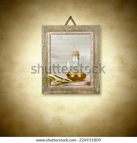 Olive oil in glass jar, picture hanging on the wall decoration and copy space