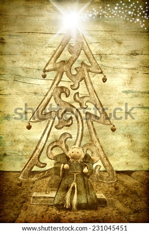 Christmas greeting card, tree, angel and Bethlehem star on old wooden grunge background