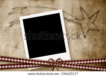 Christmas Card with empty picture frame on a background of parchment and the star of Bethlehem