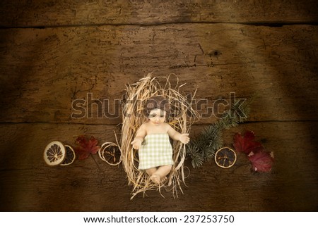 Child Jesus on a old wooden table with space for text