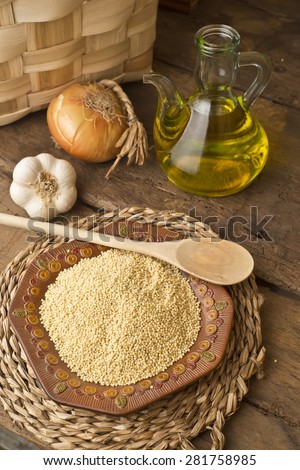 Millet from organic farming and olive oil in rustic kitchen