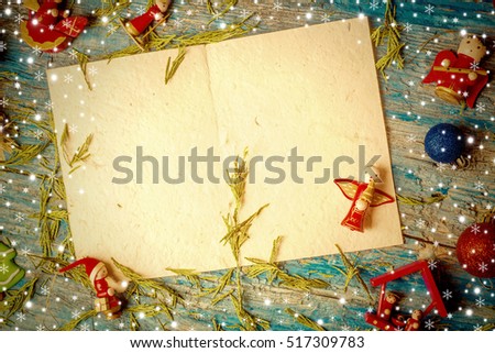 Christmas postcard , empty letter and cute christmas ornamentes on old wooden table