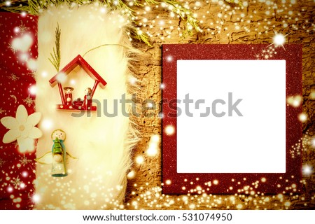 Christmas photo frame card, Nativity Scene and Angel cute figurines on old wooden background with empty photo frame.