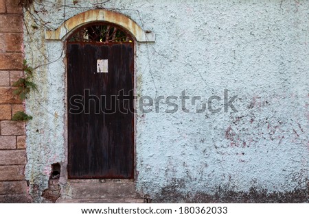 Rusty old door in backyard, Asia