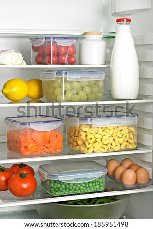 fridge interior with airtight cases and various stuff inside