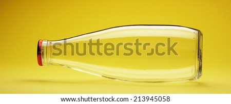 empty milk bottle on yellow background