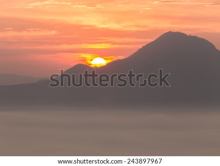 Sunrise at behind of mountain among smog sea
