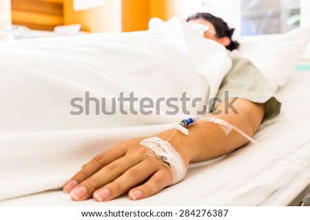 Sick man sleeping on bed at hospital