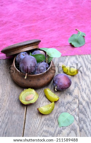 blue plums in a basket