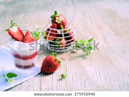 strawberries and strawberry yogurt on a wooden table.Organic food