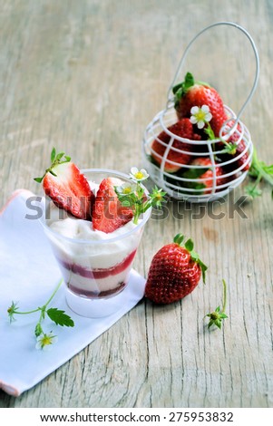 strawberries and strawberry yogurt on a wooden table.Organic food