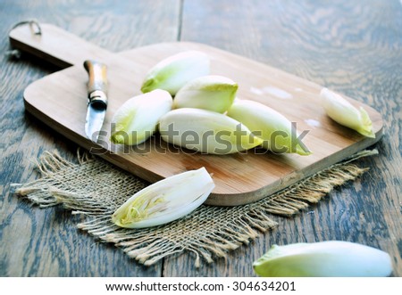 fresh endive on a wooden background, concept of vegetarian cuisine