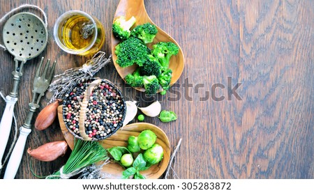 organic vegetables, green peas, broccoli, Brussels sprouts and spices on a wooden background with copy place