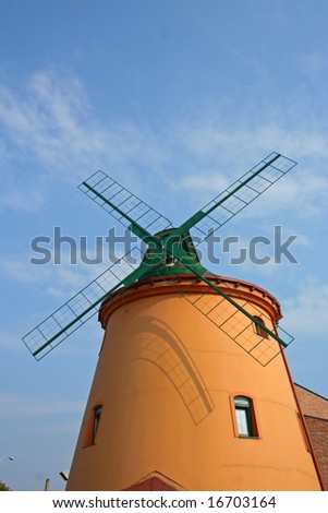 New windmill tower with four limbs on sky.