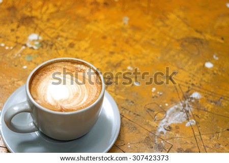hot cappuccino white cup on vintage wooden  background  focus on one point and  shallow depth of field