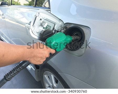 19 November 2015  Man hold oil head gasoline refill to car toyota altis oil tank