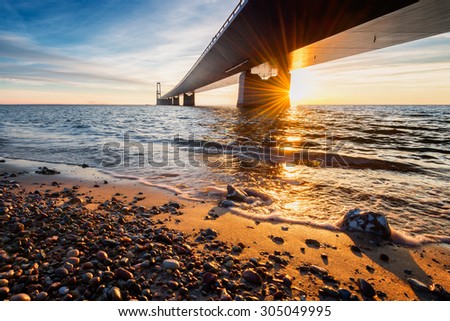 Photo of the Danish Great Belt Bridge at sunset.