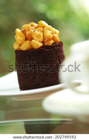 close up chocolate cake and sweet nut in white dish