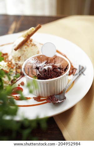 close up chocolate cake with caramel sauce and spoon