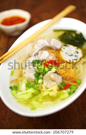 close up thai sweet soup noodle with fish in white cup