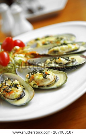 close up asian oyster and cheese roasted in white dish