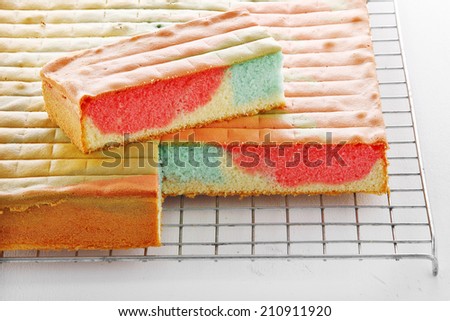 many cake in metal tray on white paper