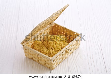 chinese dry noodle in wooden box on white background