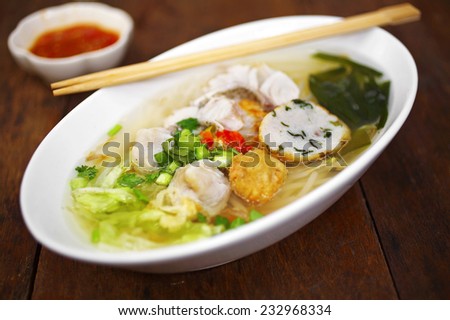 close up thai sweet soup noodle with fish in white cup