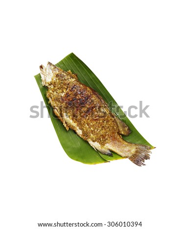 thai fish grilled with herb on banana leaf