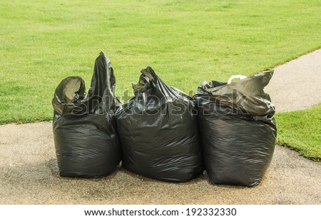 Black garbage bags inside the lawn.