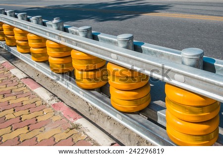 Yellow Roller Barrier  attached to the fence by the road to safety the car out the road