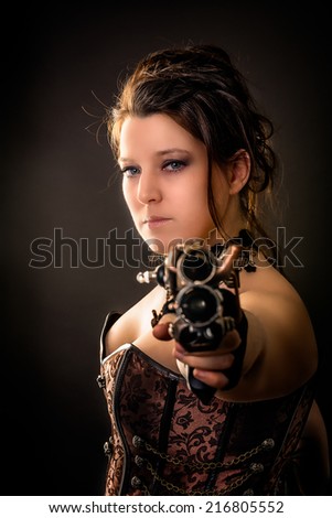 weapon girl woman in steam punk outfit aiming with a gun in the camera