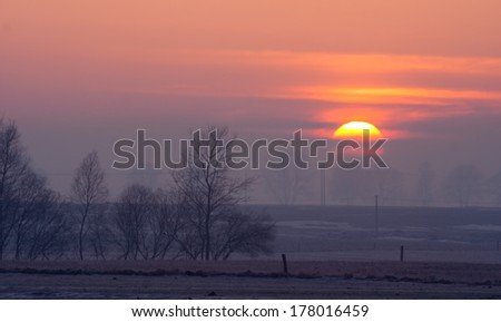winter sunrise with close up sun