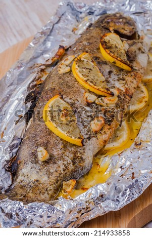 Trout fish baked with lemon, garlic and herbs