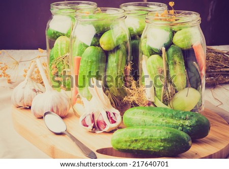 vintage photo of jars of homemade preserves with pickled cucumbers
