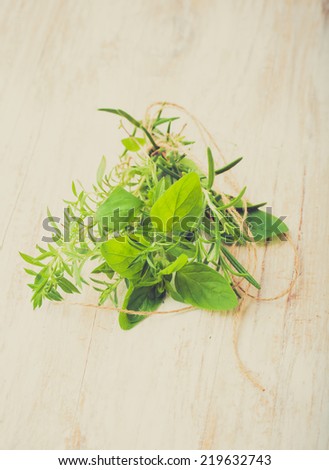 vintage photo of fresh herbs on a wooden table
