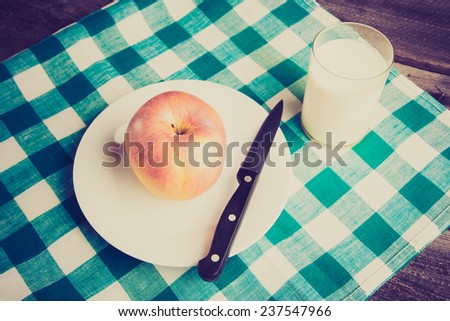 vintage photo of apple  and glass of milk on table