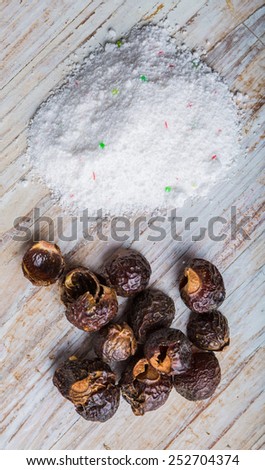 Natural soapnuts and washing powder on white table