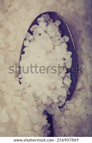 Vintage photo of sea salt grains on a spoon