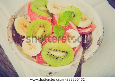 Vintage photo of fruit salad with kiwi, grapefruit and banana