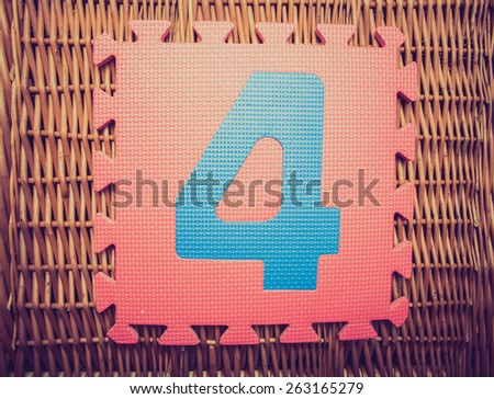 Vintage photo of numbers 4 from to created from alphabet puzzle